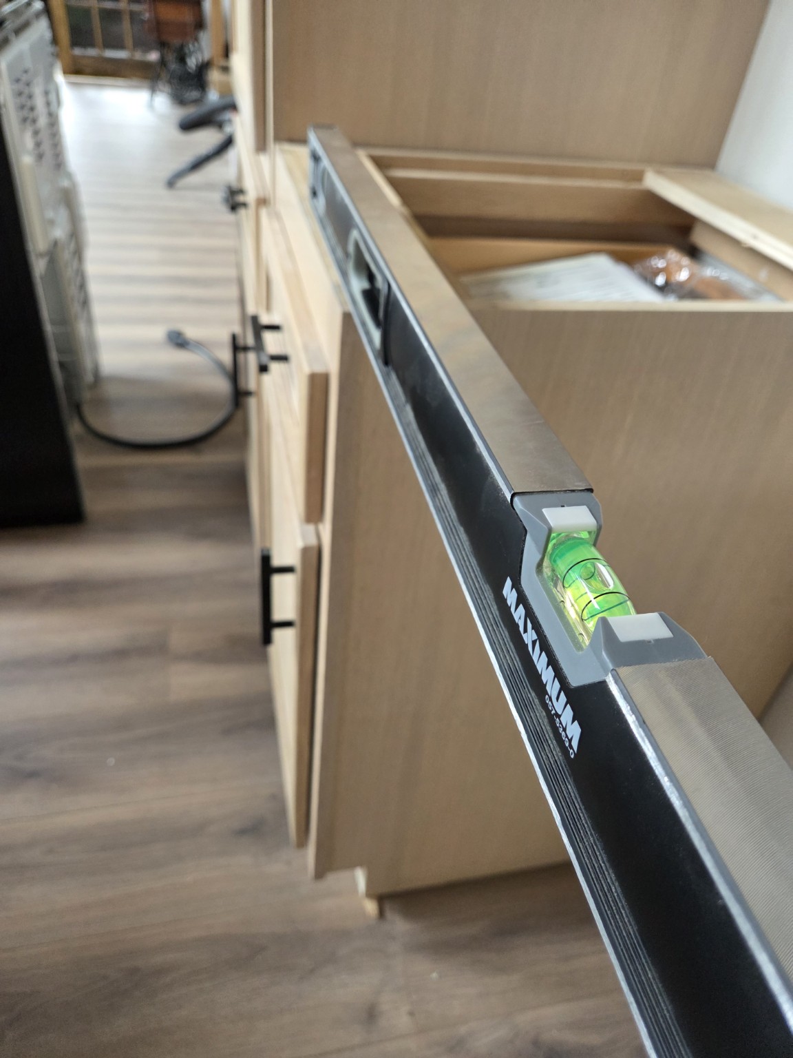 Close view of a spirit level used to check cabinet installation alignment.