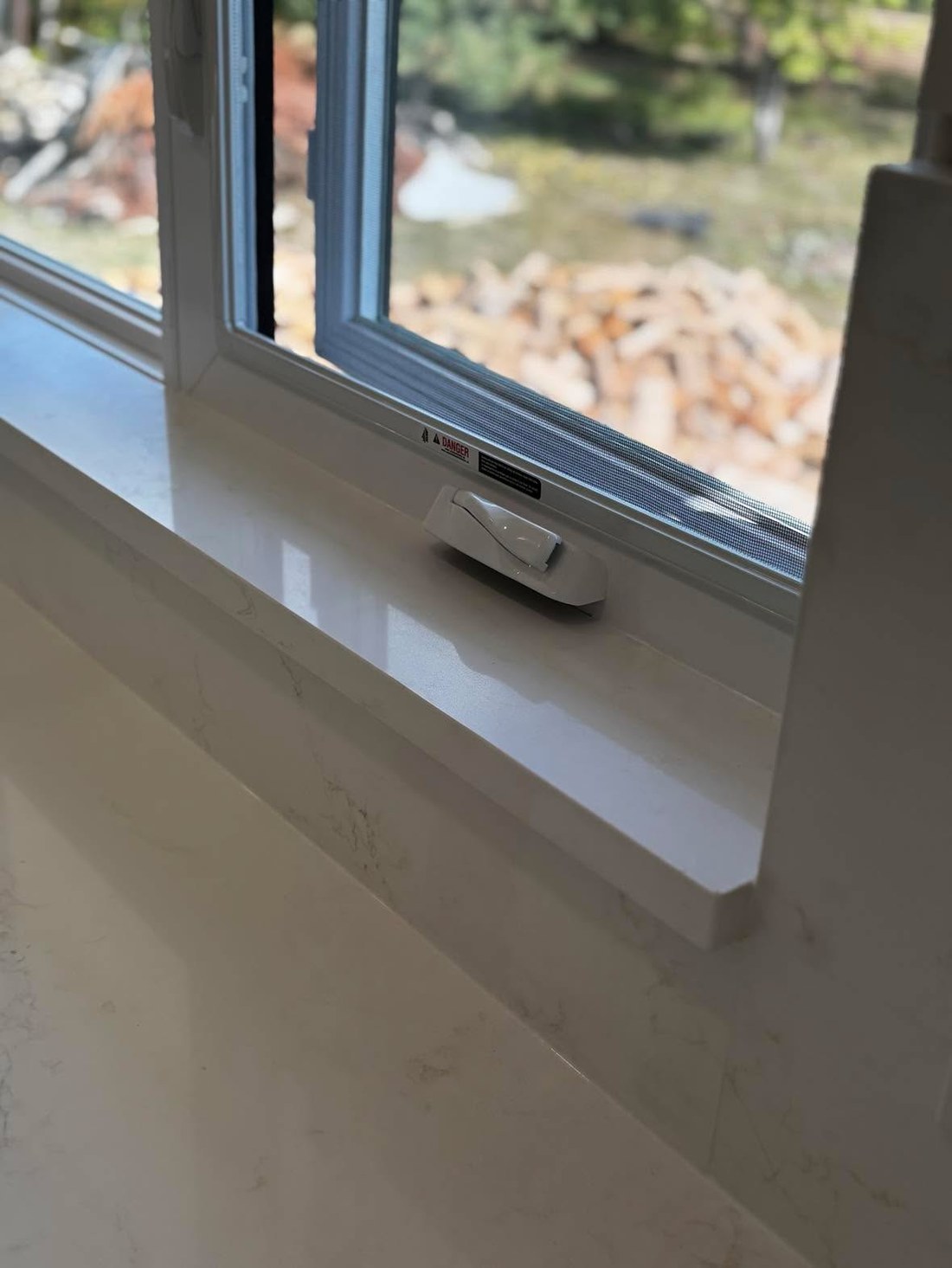 Custom white quartz window sill detail, cleanly finished by Oak Bay Rock & Tile.