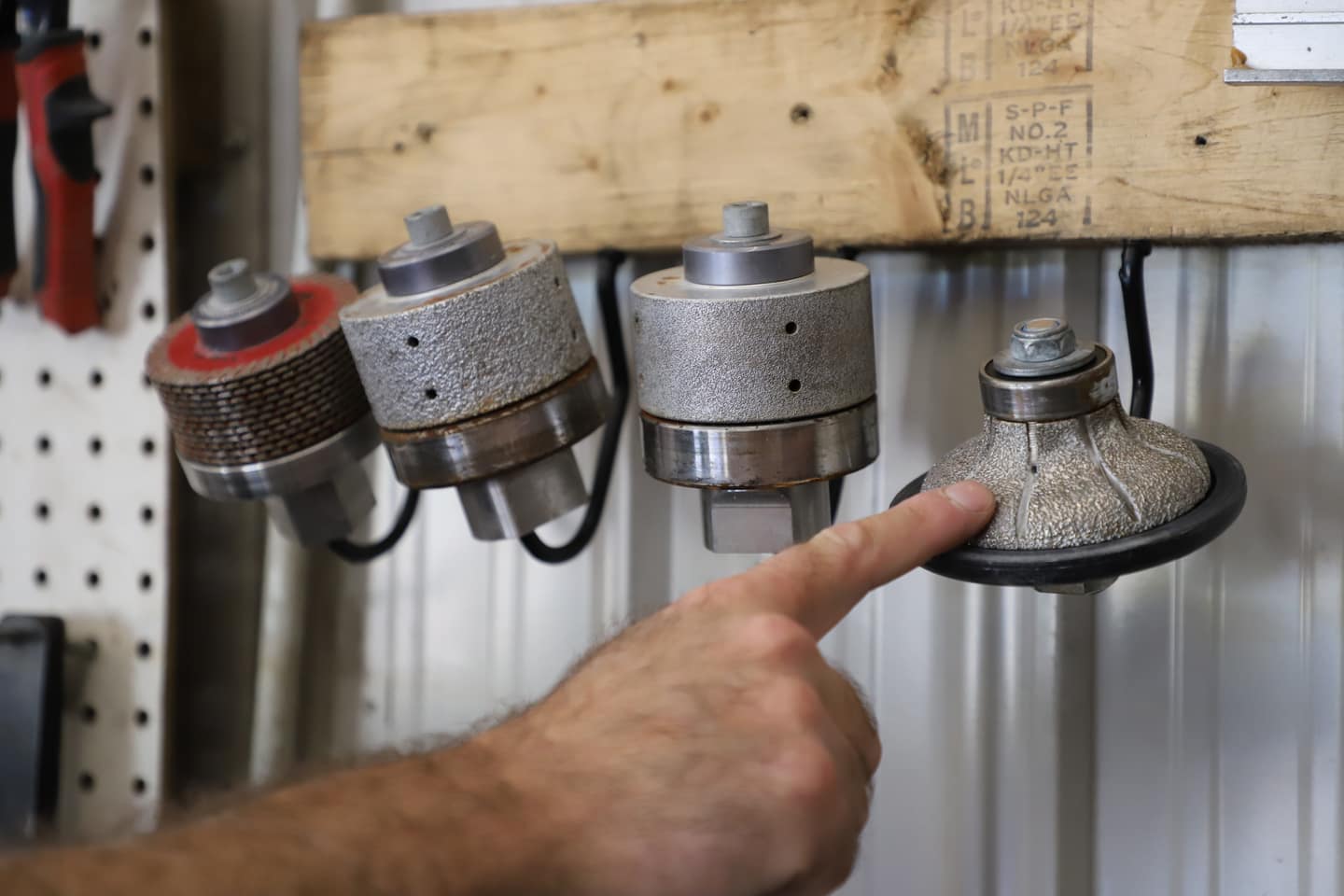 Oak Bay Rock & Tile diamond router bits — the edge profile tooling used to shape and finish every stone countertop in the shop.