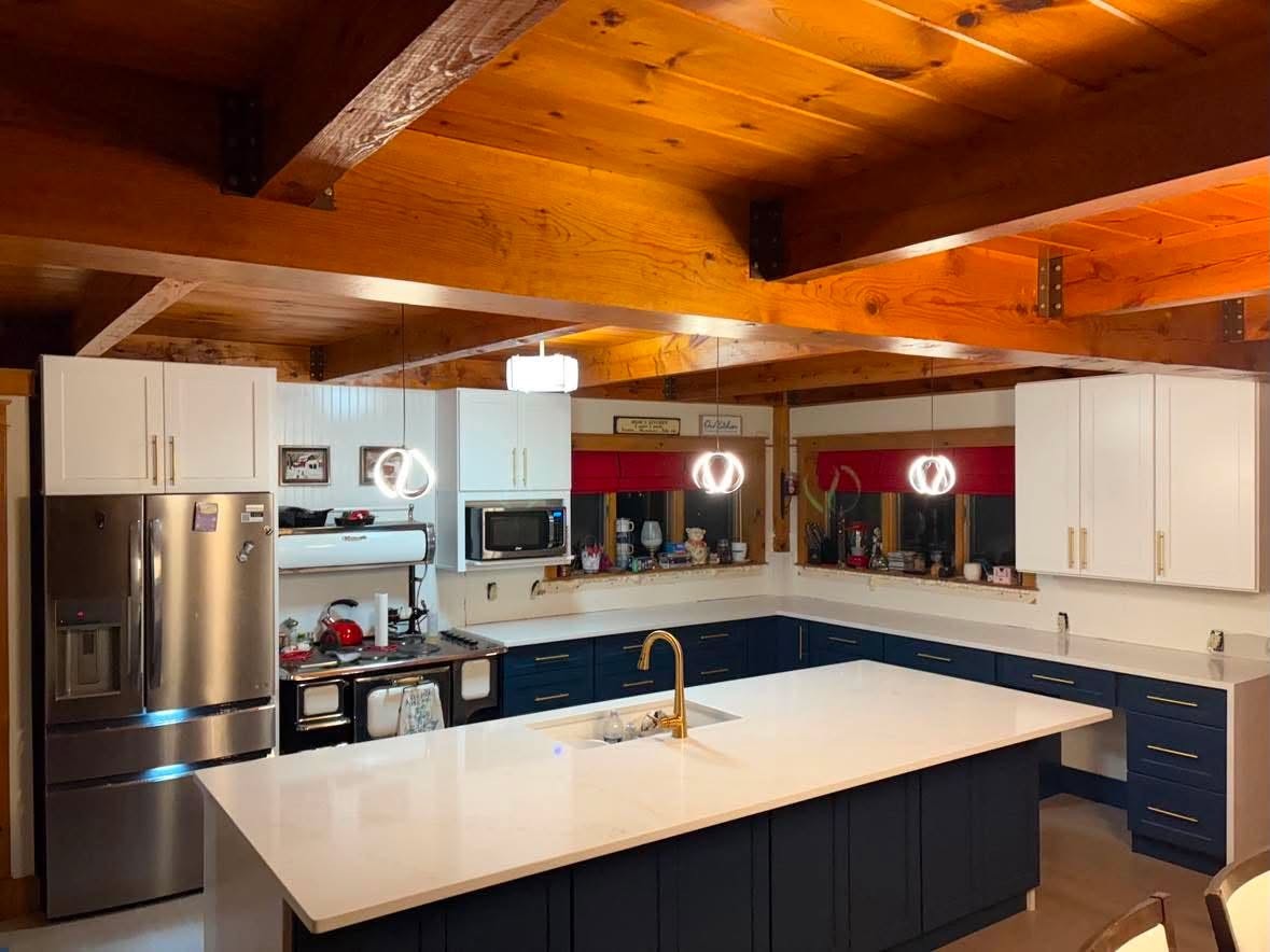 Blue cabinet kitchen with white stone island — wide view.