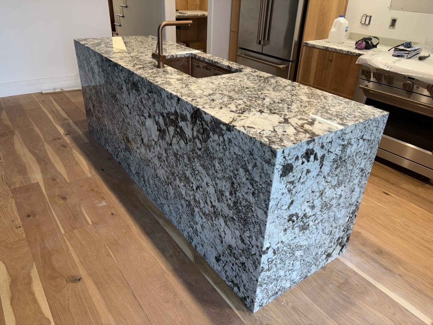 Full-height stone island — front and countertop view.