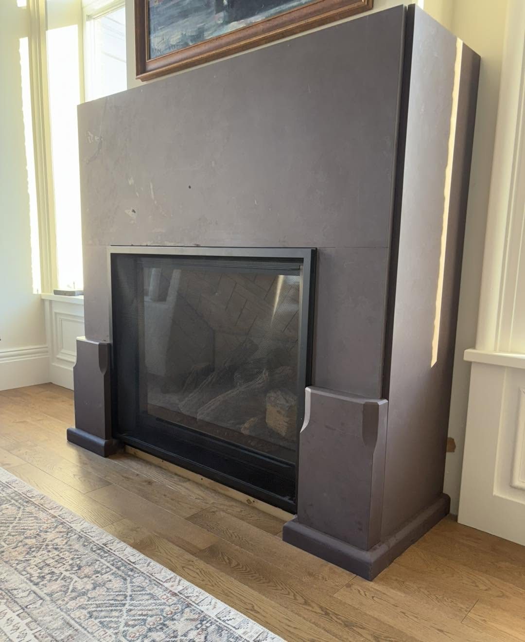 Custom stone fireplace feature during installation, before final detailing was completed.