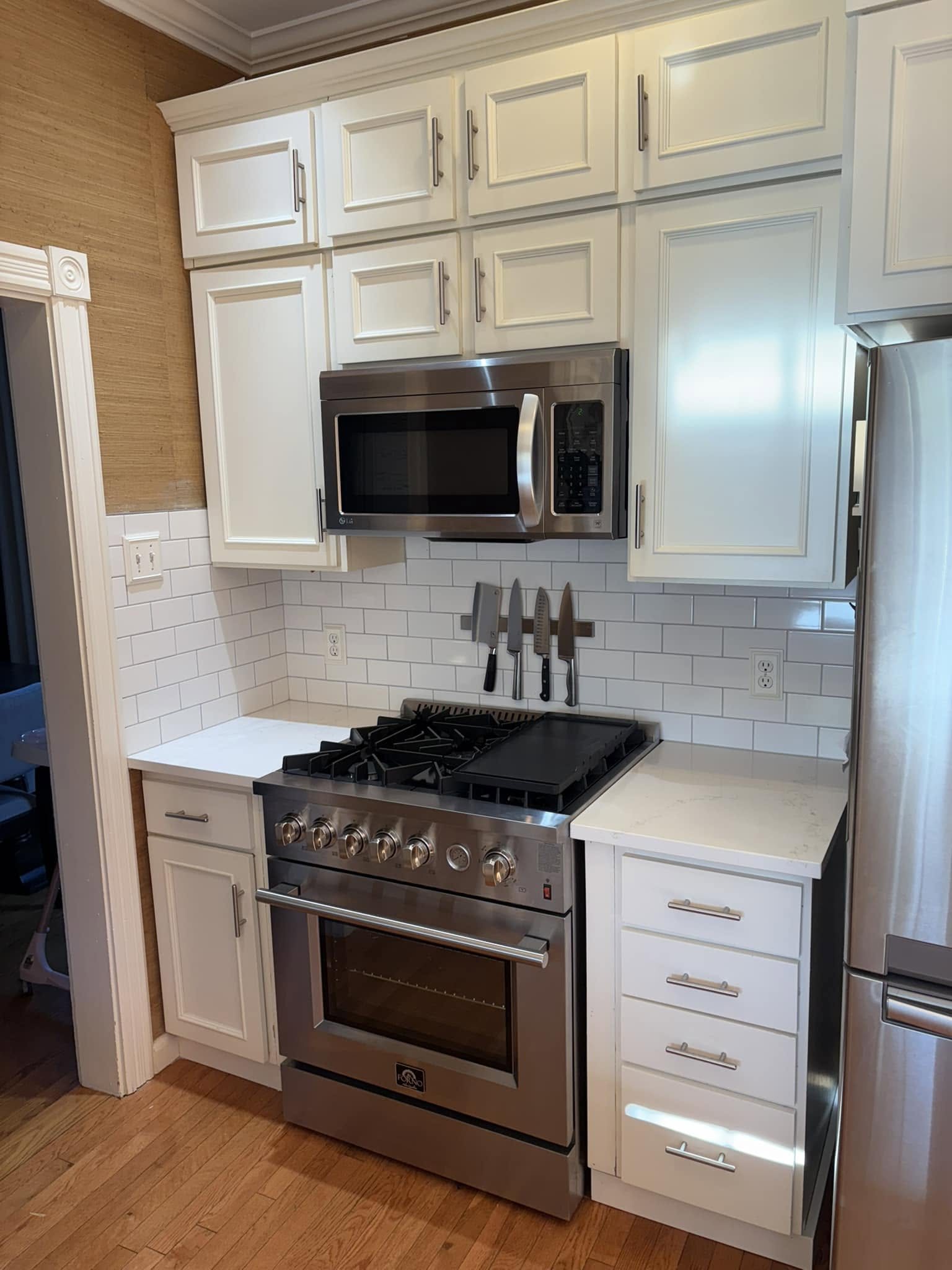 White kitchen — range and cabinet detail.