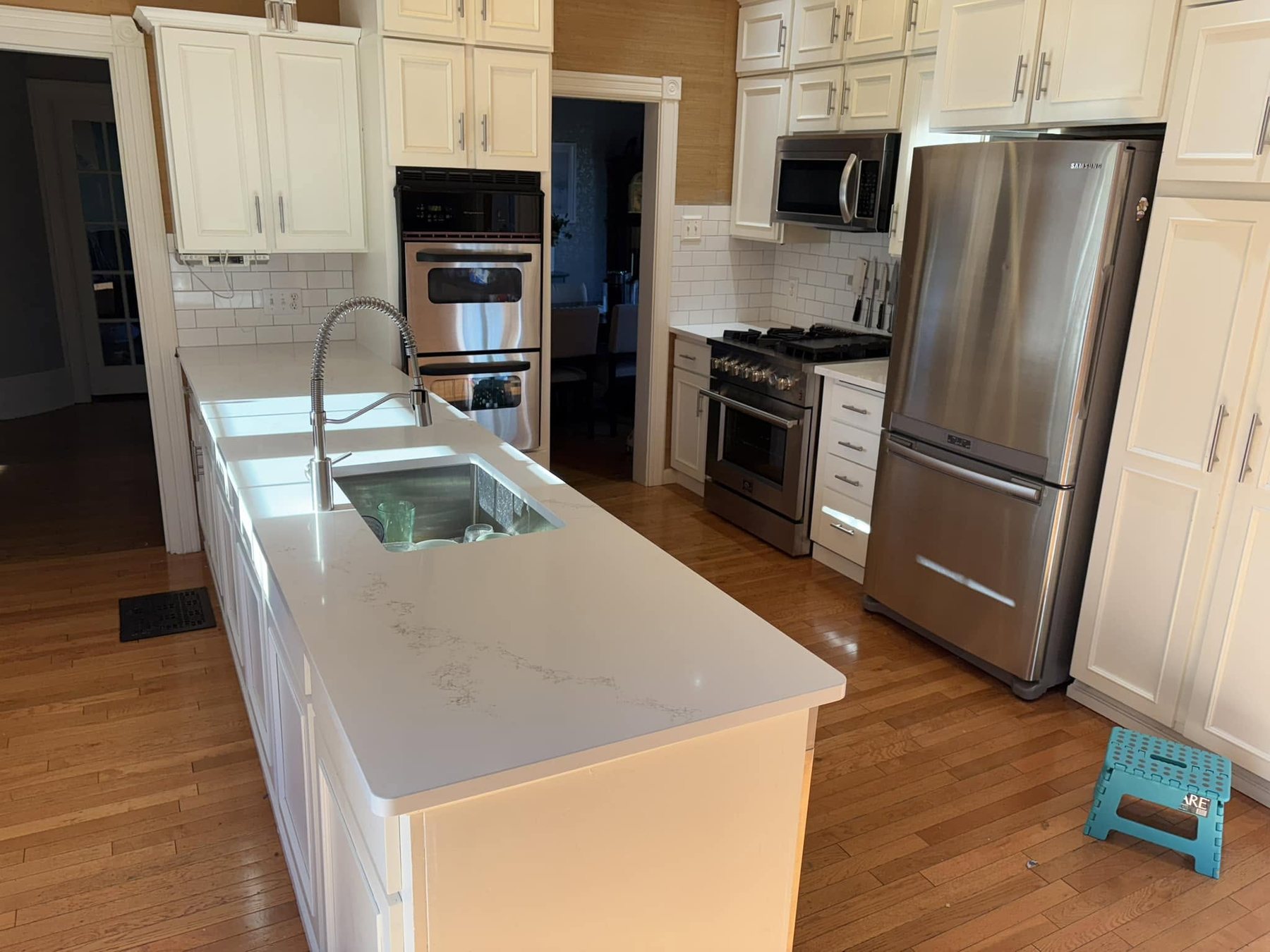 White kitchen — island and room perspective.
